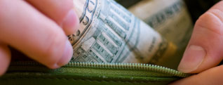 hand pulling currency from wallet